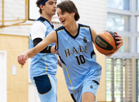 Boy dribbling past defender - basketball