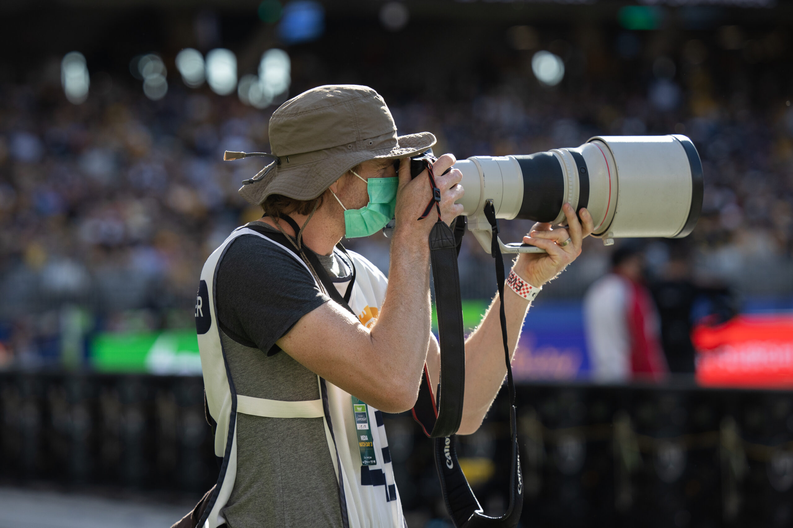 Man looking through camera with big lens